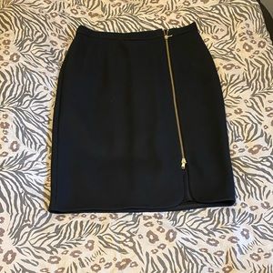 J Crew black wool knee length skirt. Gold zipper front. Fully lined. Size 10.